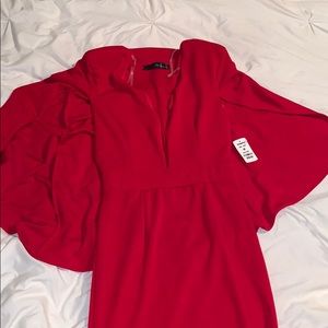 Low cut long dress with cape and shoulder pads